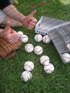 Holding 10 baseballs in a baseball glove to set a new world record