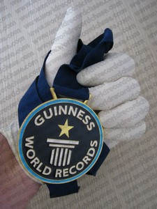 Guiness World Records medal for most gloves on one hand in a minute